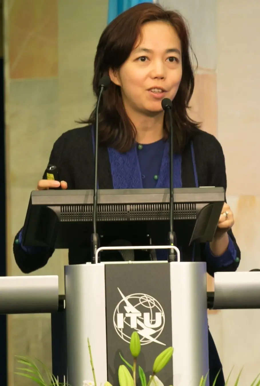 Fei-Fei Li speaking at a lectern
